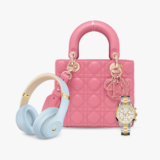 A pair of Beats Studio3 Wireless headphones, a Dior Mini Lady Dior bag in pink cannage lambskin, and a Michael Kors Accelerator Chronograph MK9112 sit against a gray background.