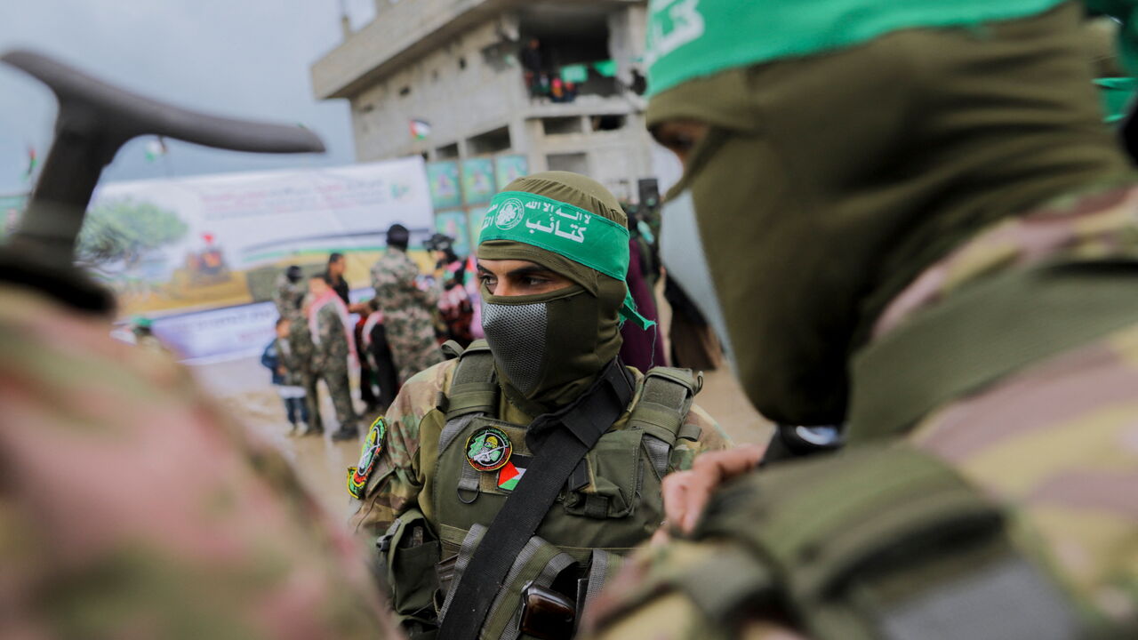 Palestinian Hamas fighters gather at the site of the handing over of Israeli hostages at the Nuseirat refugee camp in the central Gaza Strip, February 22, 2025