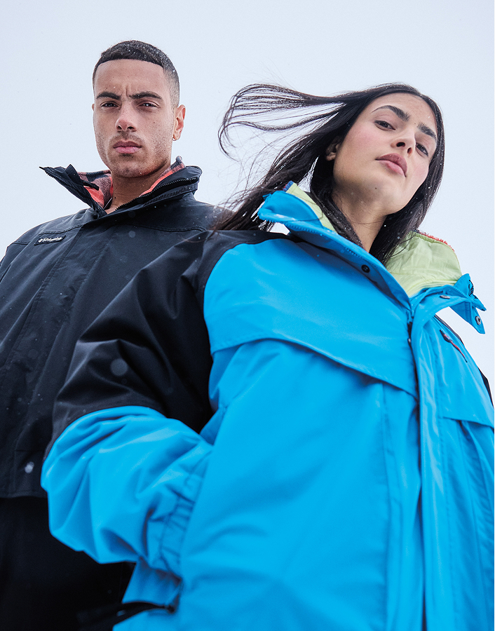 Woman holding skis in a blue jacket