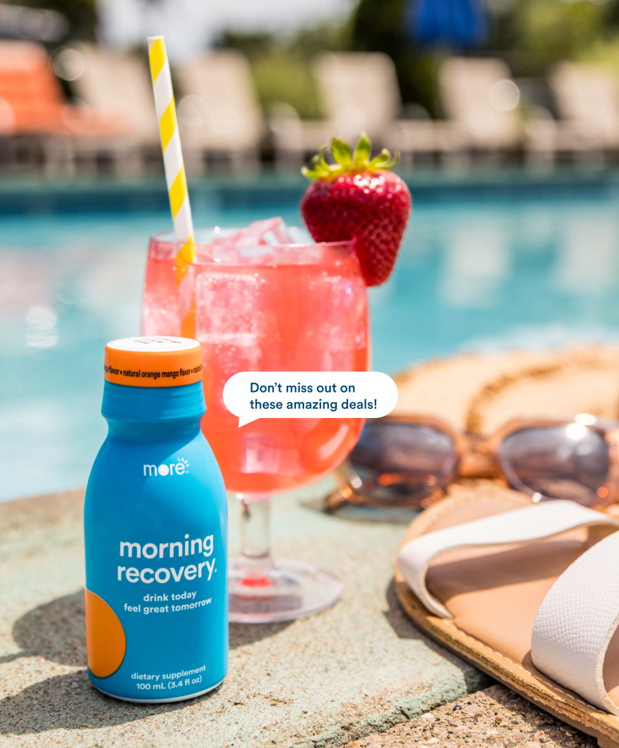  Morning Recovery bottle, next to a fruity cocktail and sunglasses by a pool