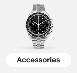 An OMEGA Speedmaster Moonwatch Professional Co-Axial Master Chronometer Chronograph on a gray tile.