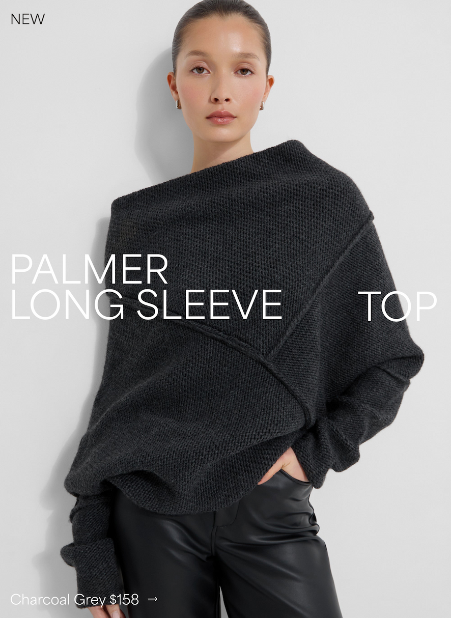 Yada sits wearing The Palmer Long Sleeve Top in Charcoal Grey, introduced as NEW, priced at $158.