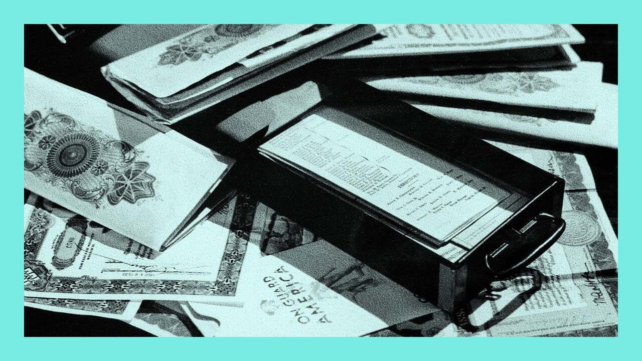 An archive image of still life of open safety deposit box showing important paper documents and valuable stocks bonds and saving certificates.