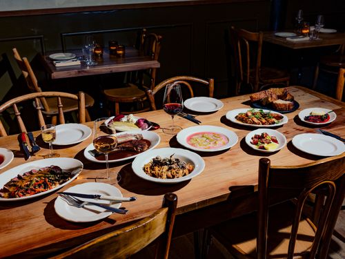 A wooden table full of various dishes.