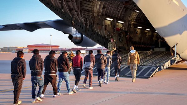 Illegal immigrants board a deportation flight from the US.
