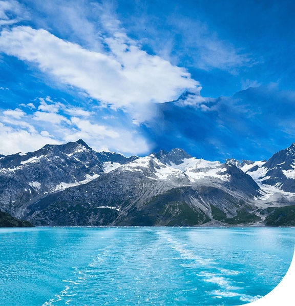 Blue water and mountains of Glacier Bay National Park from Princess cruise ship.