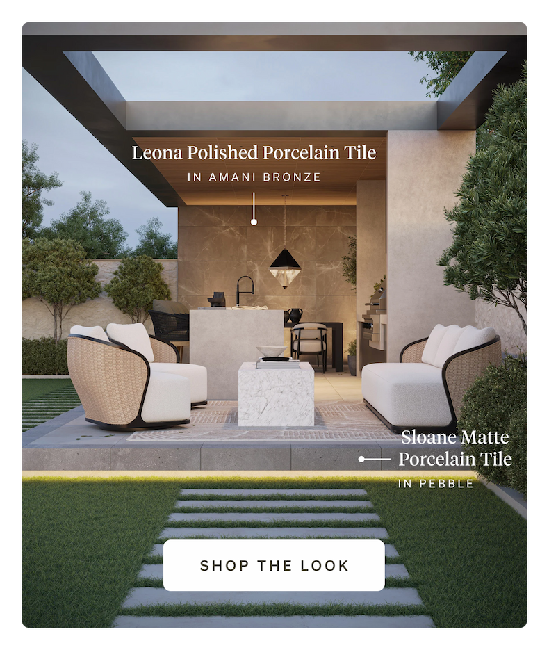 An outdoor patio with modern white seating, marble coffee table, and Amani Bronze porcelain tile.