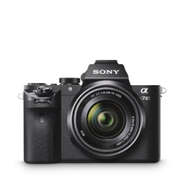 A Sony Alpha A7 II camera sits on a gray tile.