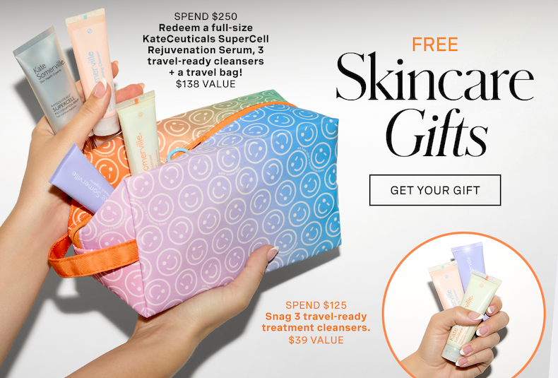 Alt text: Promotional banner for Kate Somerville advertising "FREE Skincare Gifts." The main image displays hands holding an open travel bag with a pastel pink, orange, and blue gradient and a smiley face pattern, filled with various skincare products. Text at the top left details a "Spend $250" offer to redeem a full-size KateCeuticals SuperCell Rejuvenation Serum, 3 travel-ready cleansers, and a travel bag, totaling a $138 value. An inset circle at the bottom right shows a hand holding three small tubes, highlighting a "Spend $125" offer to snag 3 travel-ready treatment cleansers worth $39. A "GET YOUR GIFT" button is positioned in the center against a clean white background.