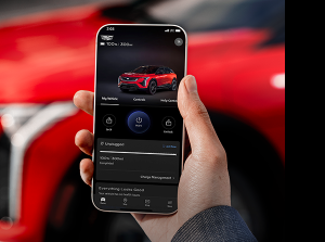 Hand holding phone displaying the myCadillac Mobile App