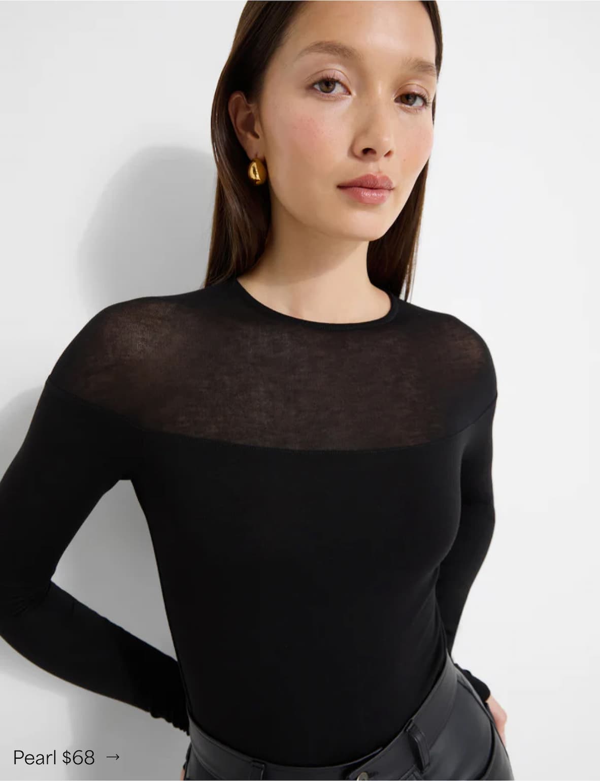 Yada wears The Pearl Top with a sheer upper panel, paired with leather pants, labeled “Pearl $68.”