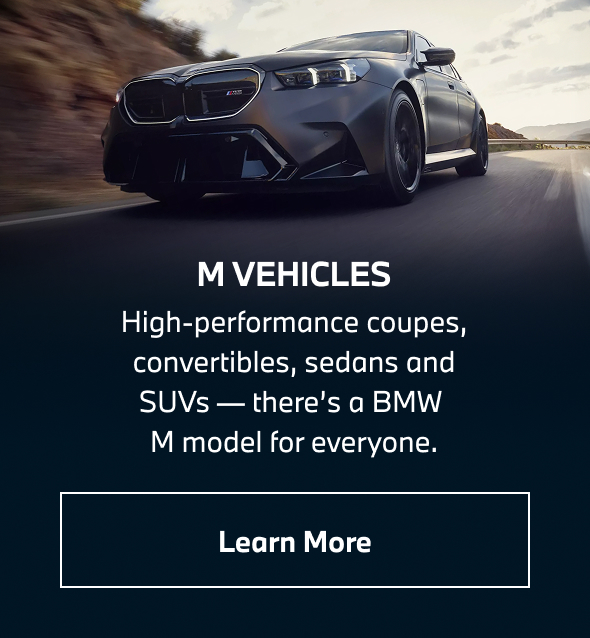 BMW M5 driving down the road. Learn more.