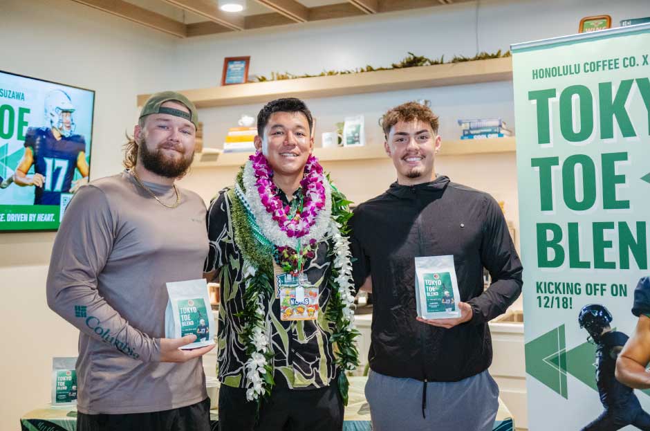 image of people posing with a bag of coffee