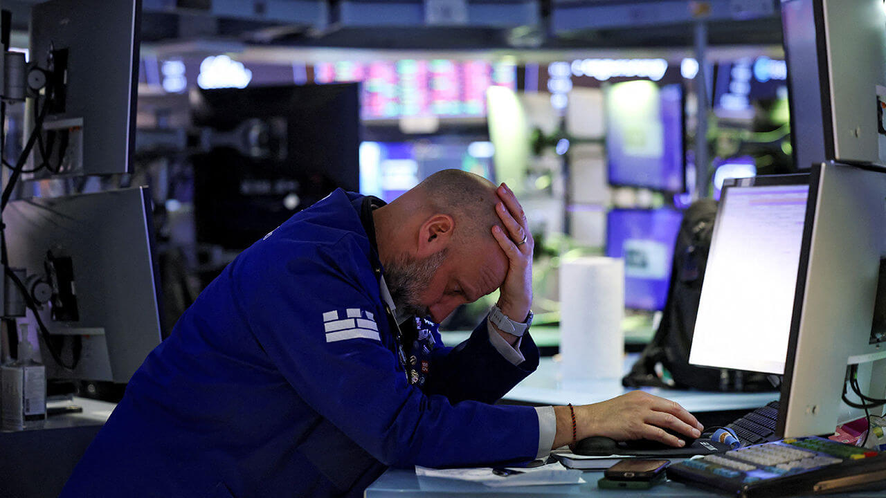 Trader works during the closing bell, on the floor at the New York Stock Exchange (NYSE) in New York City