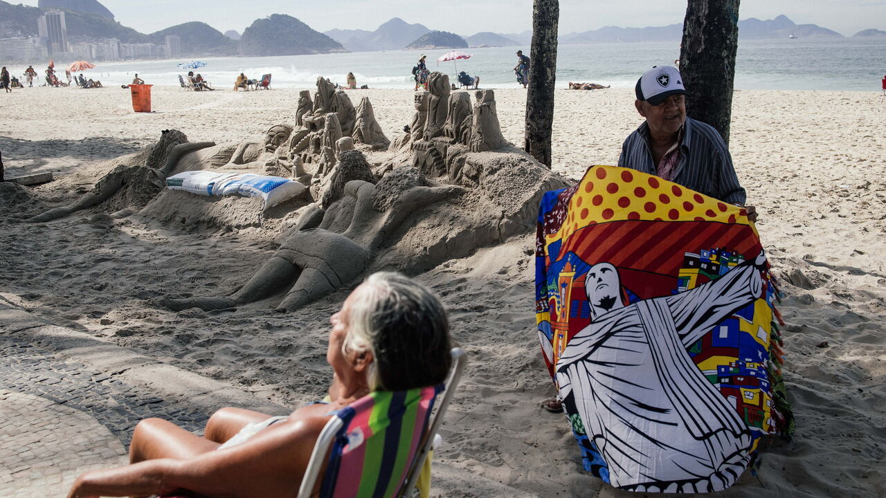 A man sells towels on Copacabana Beach in Rio de Janeiro.