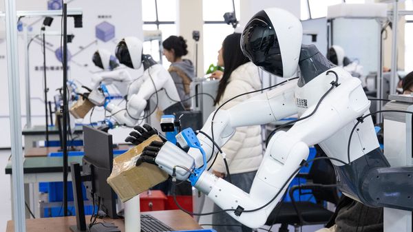  Staff members operate robots to collect data at a humanoid robot innovation center in Wuhan East Lake High-tech Development Zone, also known as the optics valley of China, in Wuhan.