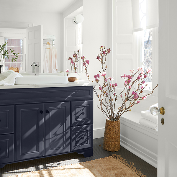 A white painted bathroom with a black vanity.