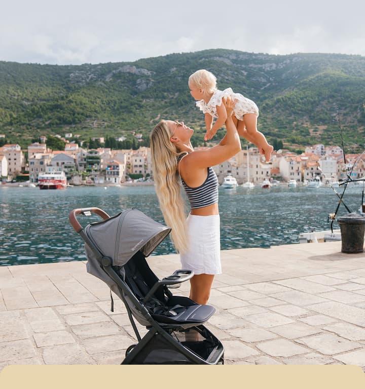Mom lifting baby 