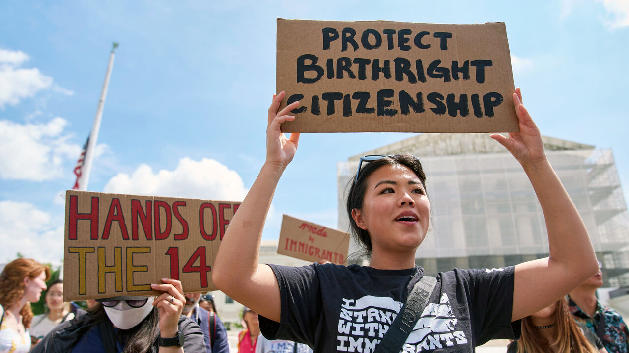 A protester holds a sign in support of birthright citizenship outside of the Supreme Court in Washington D.C.