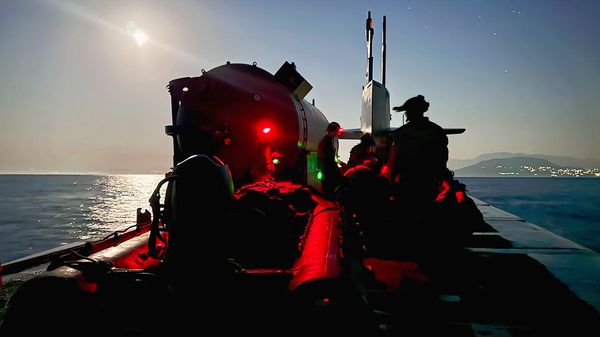U.S. Marines with 2nd Force Reconnaissance Company conduct final topside checks of a combat rubber raiding craft  before beginning a nighttime launch and recovery operations on Ohio-class guided-missile submarine USS Georgia in the Mediterranean Sea.