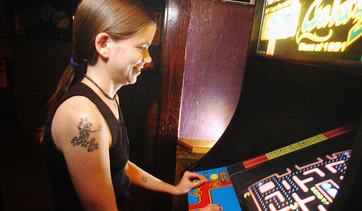 A girl plays Pac-Man.