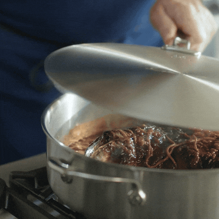IMG: Shrimp cooked in NanoBond skillet, with sides and glasses of wine, displayed on marble countertop