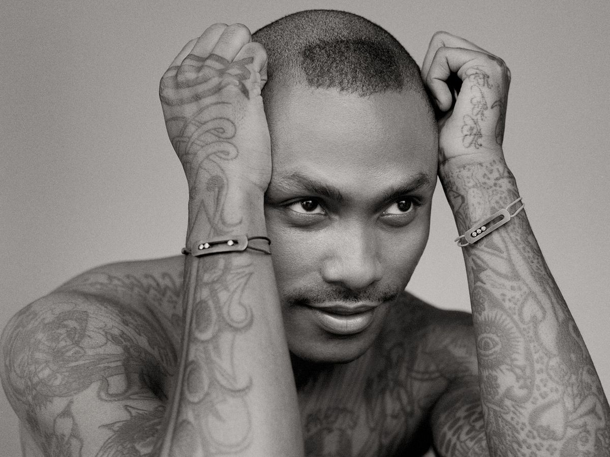 Steve Lacy with his hands on his head, looking to the right of the camera.
