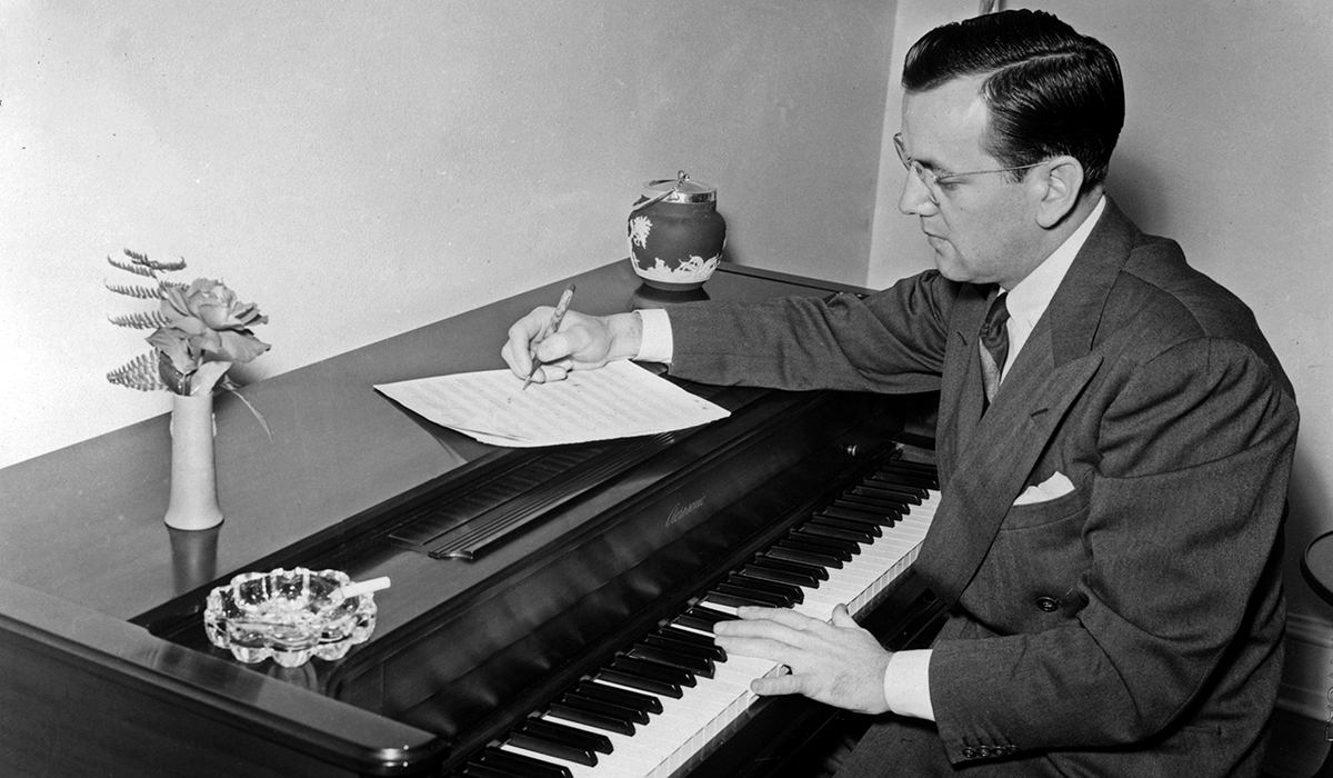 Glenn Miller writes at a piano.