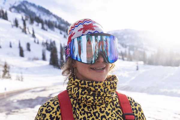 an image of a woman wearing a leopard print jacket and goggles