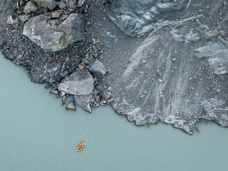 A boat on a lake near a landslide