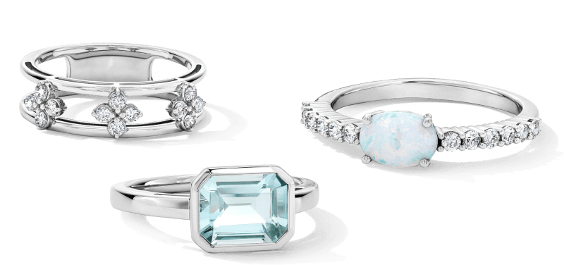 Three rings each with a diamond, opal and gemstone respectively. 