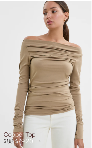 Carmel with a warm complexion and ponytail shows bare shoulders in The Cooper Top.