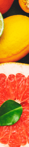 Various citric fruits in the background.