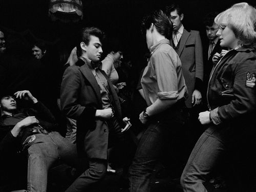 A group of young people dance.