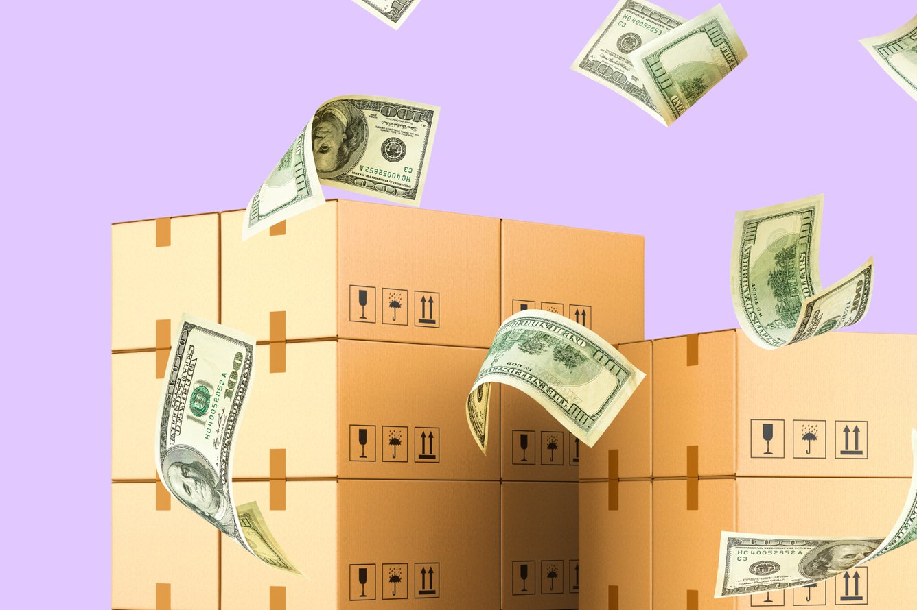 A stack of shipping boxes with money falling over them