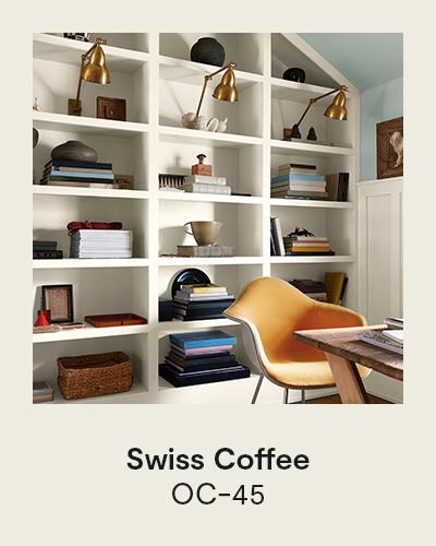 Swiss Coffee OC-45 - A warm off-white built-in shelving unit displaying books, with a yellow chair in front.