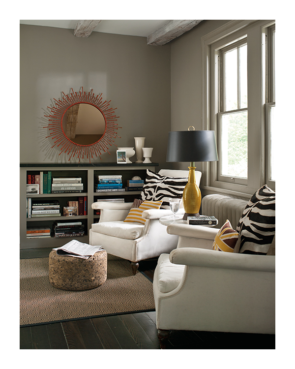 A living room with deep taupe painted walls, trim, and a low built-in bookcase.