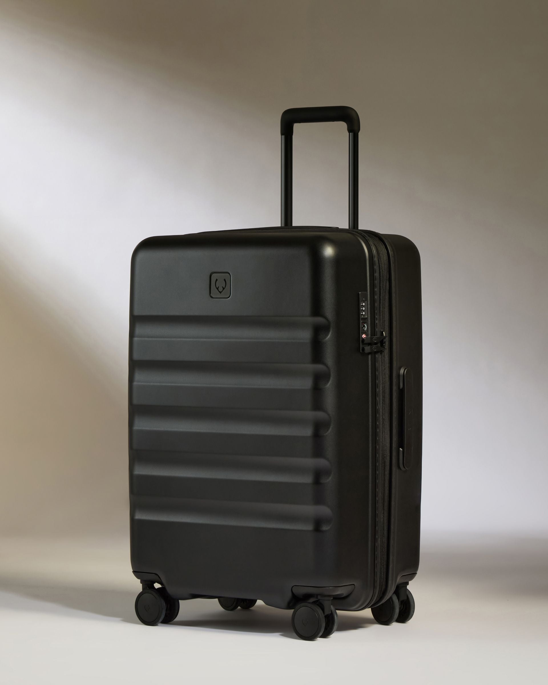 Image of Medium Luggage in Black - Icon Stripe