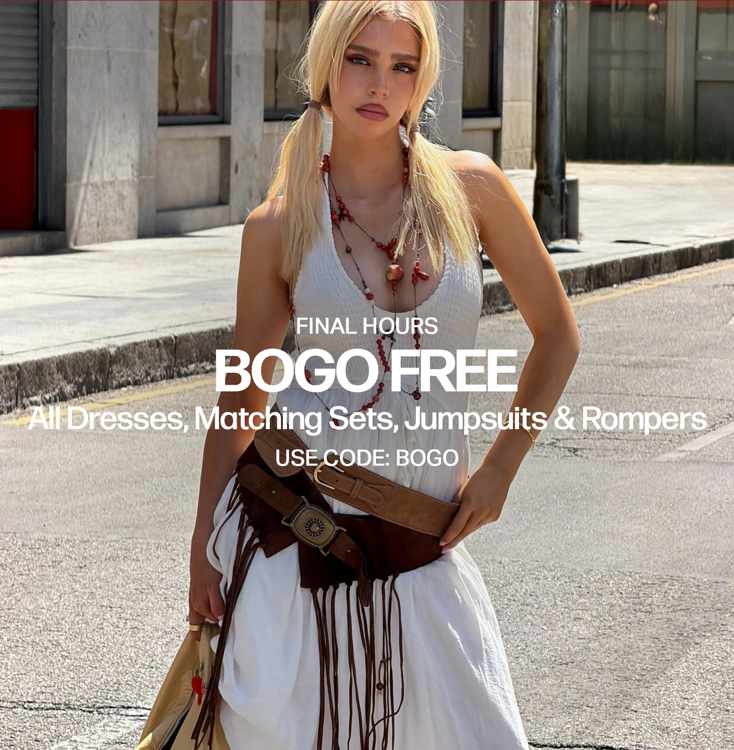 Blonde model in white dress, brown fringed belt, red necklace, promoting a BOGO FREE sale on dresses, matching sets, jumpsuits, rompers.