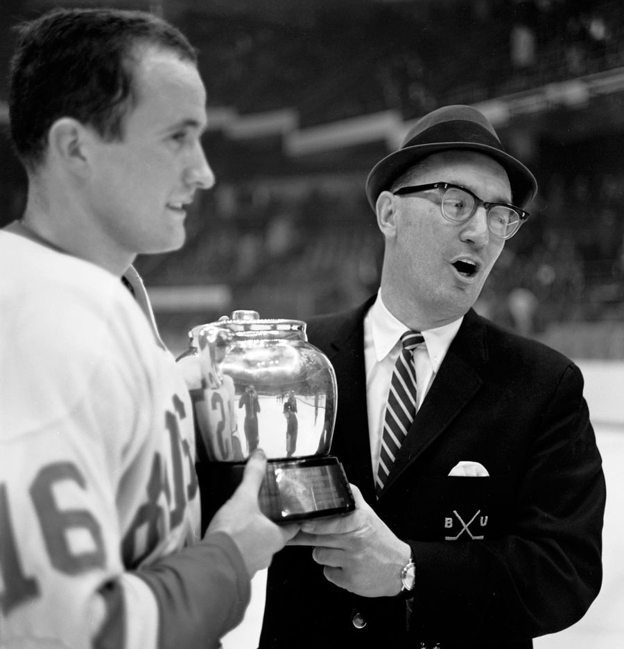 2/14/1966 -- Boston, Massachusetts Boston University Men's Ice Hockey player Dennis O'Connell #16, holds the Beanpot trophy with Head coach Jack Kelley after winning the Championship game against Harvard
9 - 2. Photo by Boston University Photography