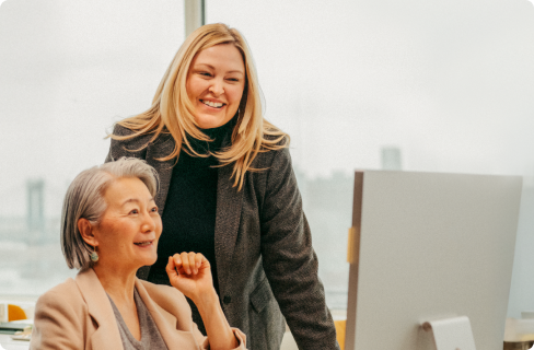 Photo of women looking at monitor in office