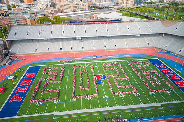 Groups of graduating students spelling out the numbers 2026 on Franklin Field.