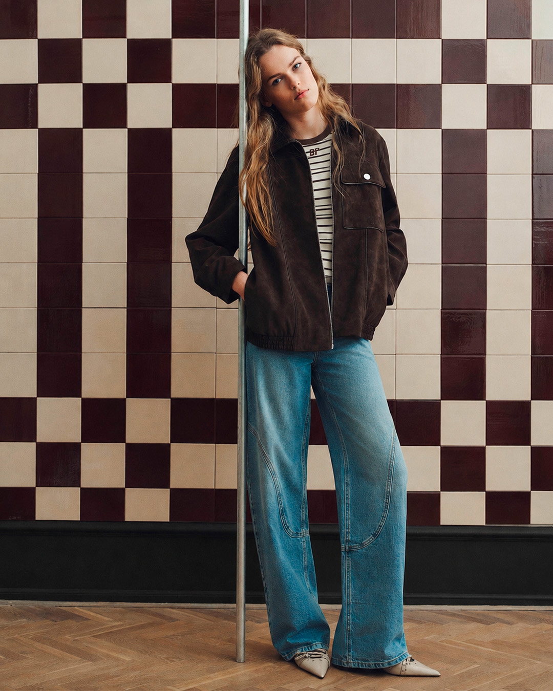 Model in denim jeans and suede jacket 