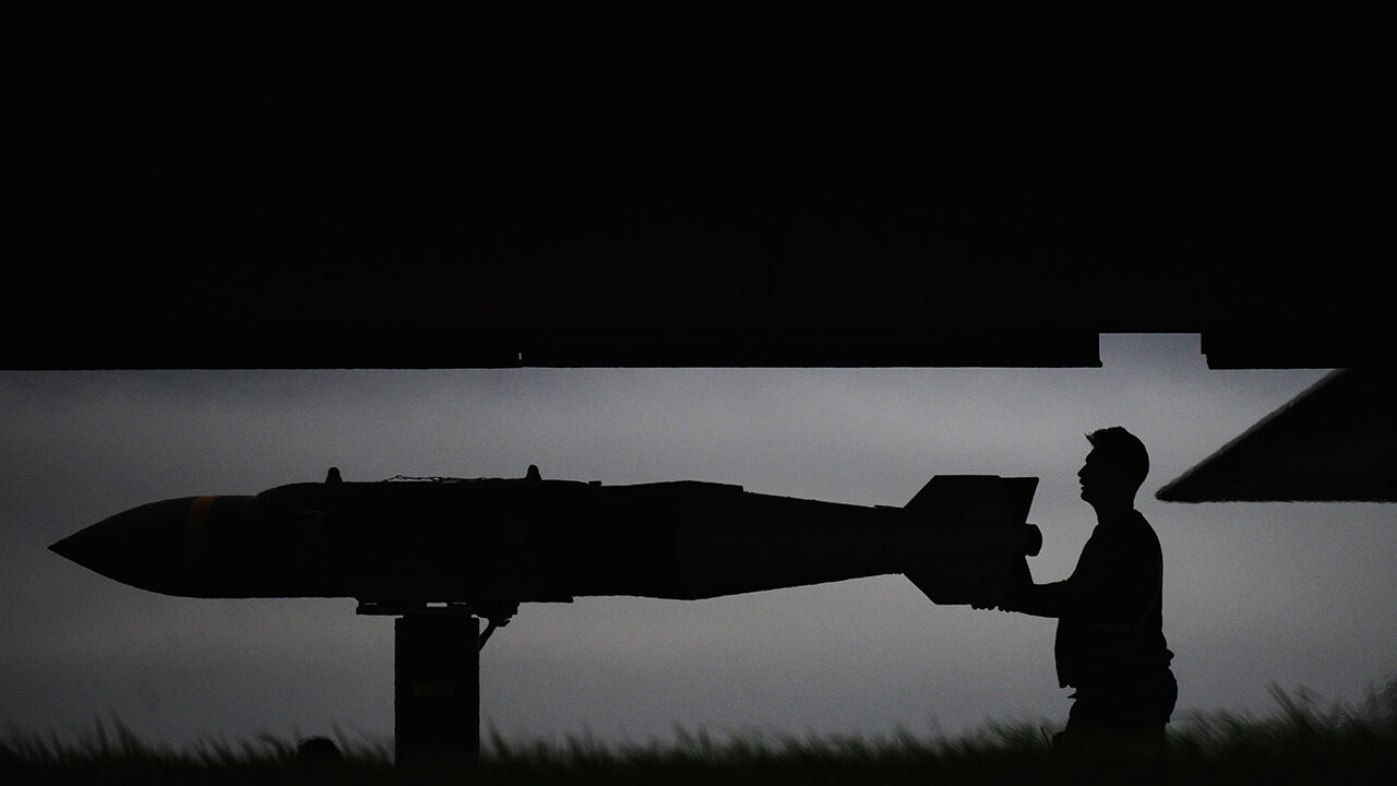 Munitions, believed to be JDAM bunker-busting bombs, are loaded into a US Air Force B-1B Lancer bomber 