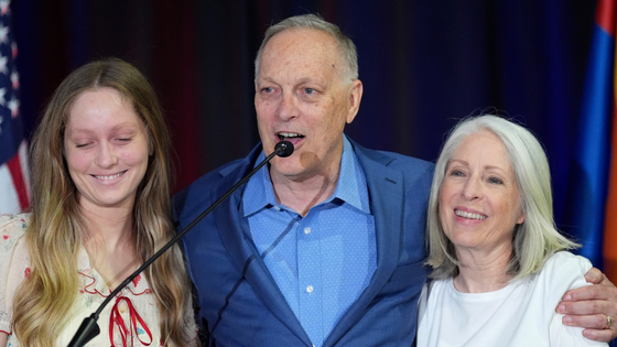 Three people pose for a photograph.