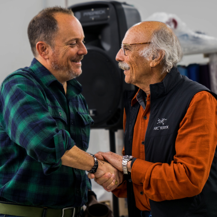 Learn about Darn Tough's history - Ric Cabot and his father, Marc Cabot, shake hands