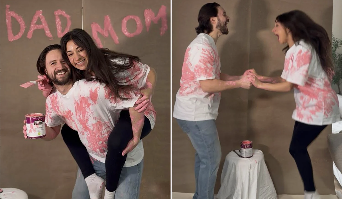 A man and woman celebrate with pink pain in hand and on shirts.