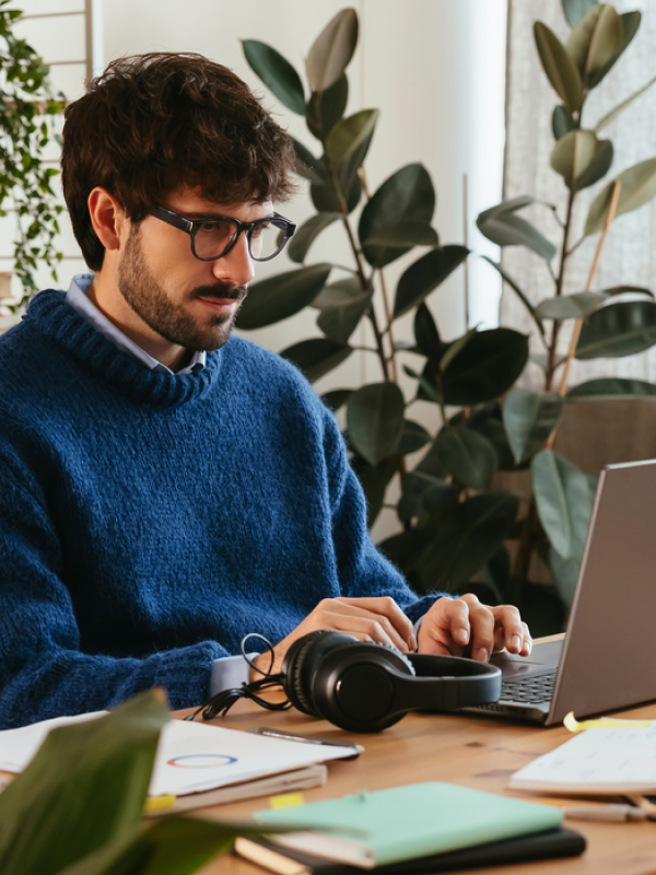 Photo-of-a-man-focused-on-his-laptop-in-home-office