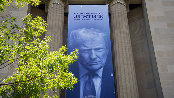 A large image of President Trump hanging from a federal building.