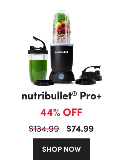 A black nutribullet Pro+ personal blender with a glowing blue pulse button next to a travel cup containing a green smoothie.